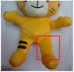 Missing screen printing. The red rectangle marks the missing print on the toy’s leg.