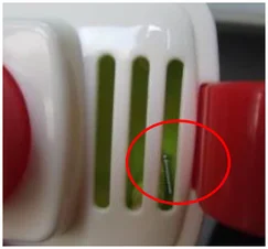 Stray screw inside the product. The red ellipse identifies the screw introduced as foreign matter.