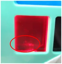 Bubble in a red molded part. The ellipse identifies the bubble in the red window.