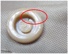 Cracked component. The ellipse marks the crack in the round component.