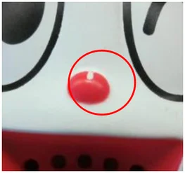 Missing paint coverage. The ellipse highlights incomplete paint coverage on the red detail.