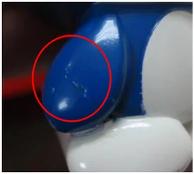 Paint buildup. The ellipse marks the source’s paint-accumulation example.