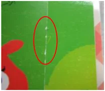 Worn paper edge. The ellipse follows wear along the green page edge.