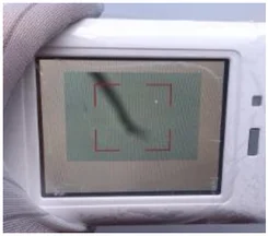 Dark shadow on the display. The source photograph shows a dark shadow across the screen.