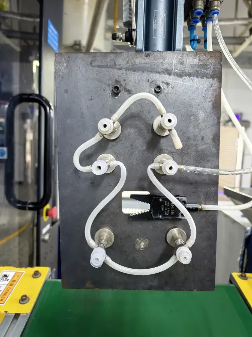 Steel-plate take-out fixture with suction cups beside the molding machine conveyor